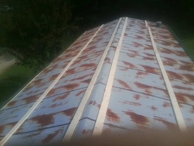 Rusted metal roof panels with new wood purlins before replacement — Storm Damage Roof Repair in Beresford by Roofing Brothers